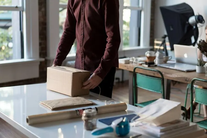 A shop owner packing an order