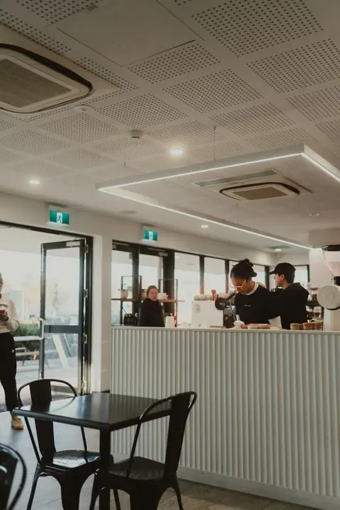 Baristas in a bright cafe