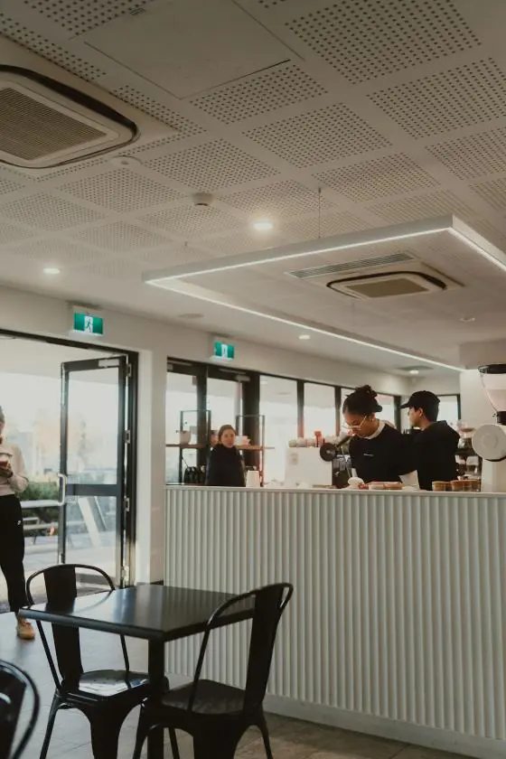 Baristas in a bright cafe