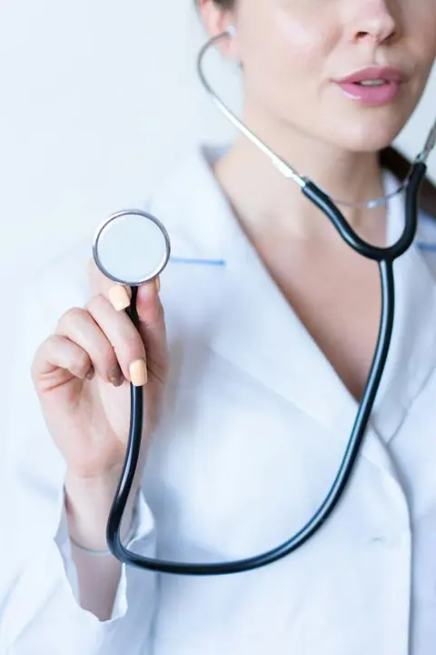 A doctor holding a stethoscope