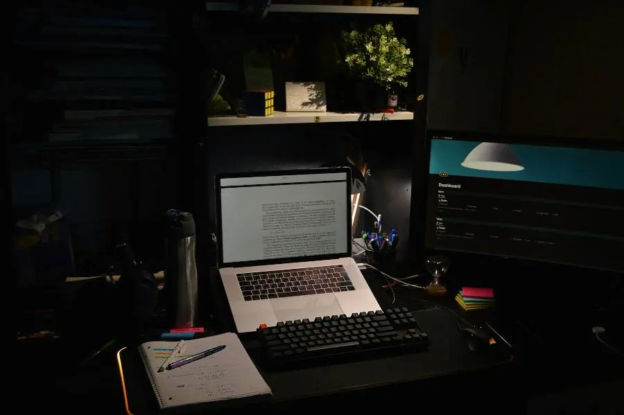 A laptop on a desk in a dark room