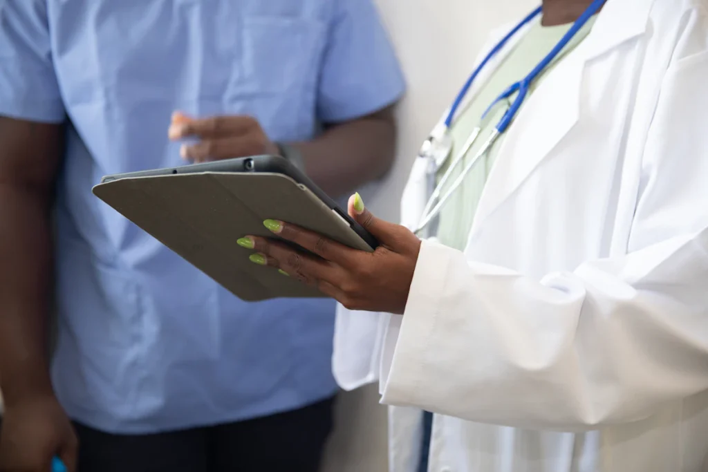 Doctor showing a patient information on a tablet during a consultation, the kind of health advice Google treats as YMYL