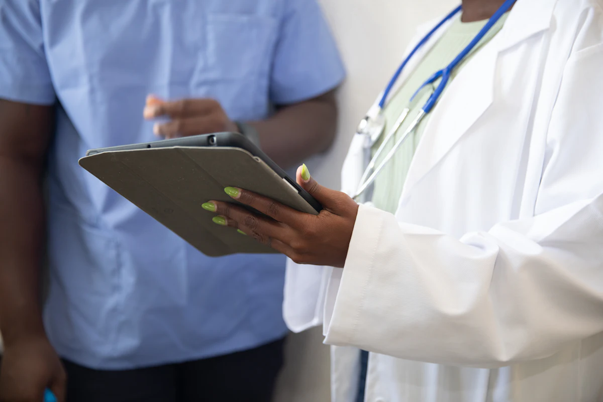 Doctor showing a patient information on a tablet during a consultation, the kind of health advice Google treats as YMYL
