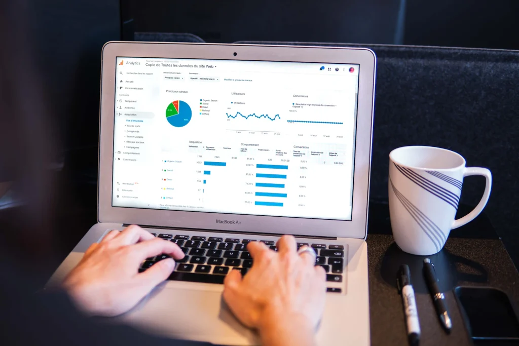 Laptop screen showing a website analytics overview report with traffic charts